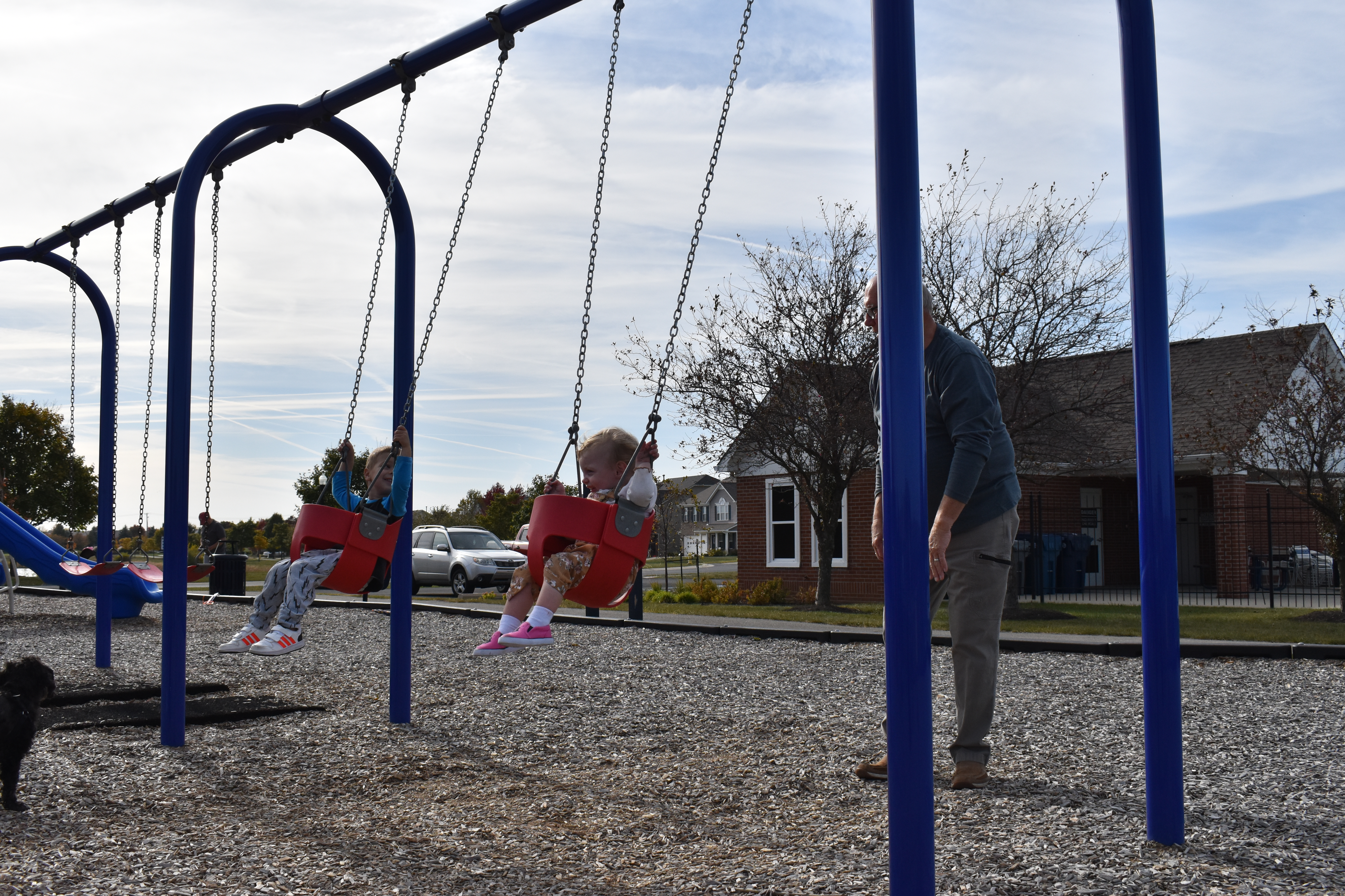 younger children playing on swing set